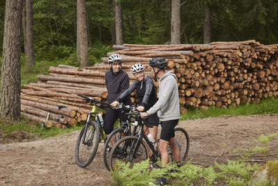 Friends cycling in forest