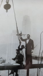 People standing by railing during winter