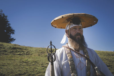 Low angle view of person on field against clear sky