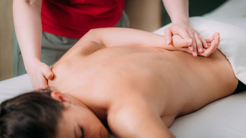 Back massage in a massage salon, woman having a relaxing back massage.