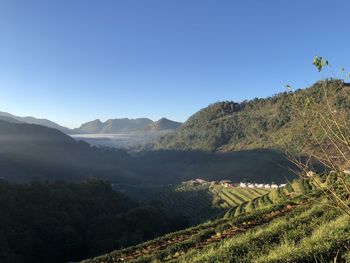 Scenic view of mountains against clear blue sky