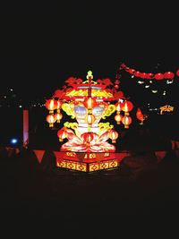 Illuminated temple against sky at night