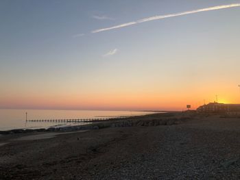 Scenic view of beach against sky during sunset