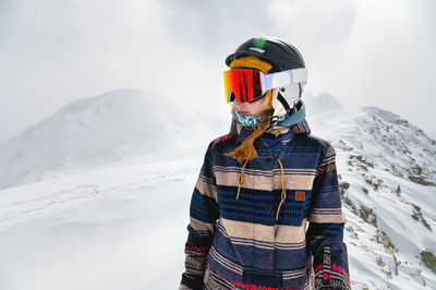 Skier, skiing, winter sports, female skier portrait. a beautiful girl stands against the backdrop of
