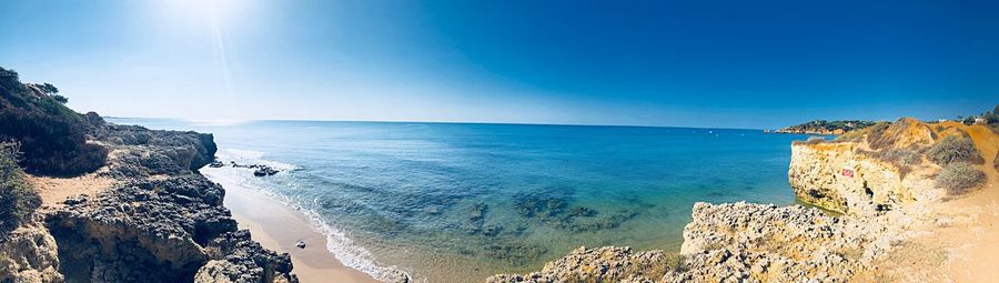 Panoramic view of sea against blue sky