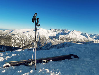 Scenic view of snowcapped mountains against clear blue sky