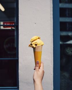 Close-up of hand holding ice cream cone