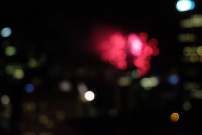 Defocused image of illuminated city at night