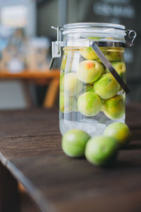 Fruits in jar on table