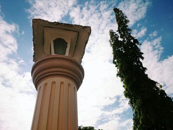 Low angle view of building against cloudy sky