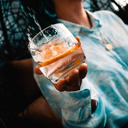 Close-up of hand holding beer glass