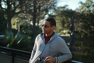 Man looking away while standing outdoors