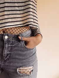 Midsection of woman standing against white background