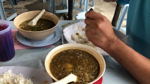 Close-up of person preparing food on table