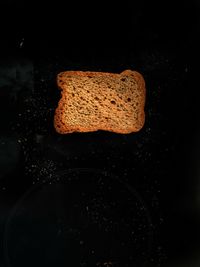 High angle view of bread on table against black background
