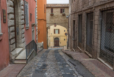 Narrow alley amidst buildings in city