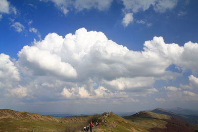 Scenic view of land and mountains against sky