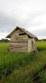 Built structure on field against sky