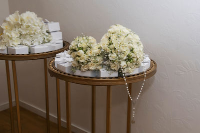 High angle view of white flower vase on table against wall