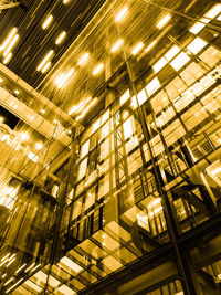 Low angle view of illuminated modern building at night