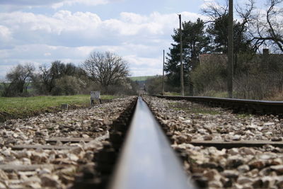 Surface level of railroad tracks against sky