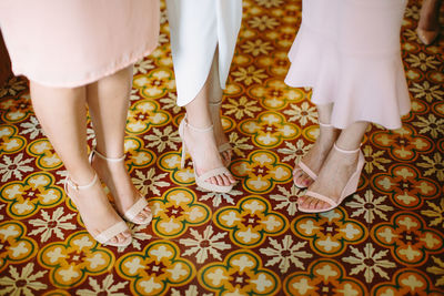 Low section of woman standing on tiled floor