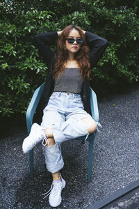 Portrait of young woman sitting outdoors