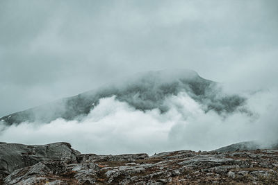 Smoke emitting from volcanic mountain against sky