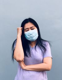 Portrait of woman standing against white background