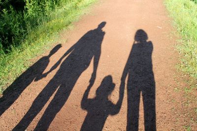 Shadow of man on road