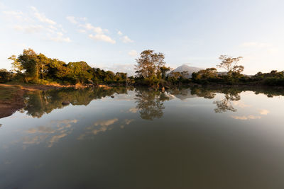 Reflection of trees in lake against sky