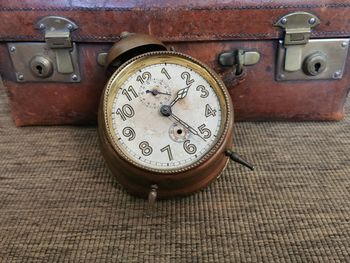 Close-up of old clock on table