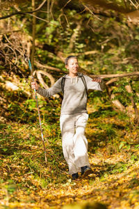 Walking mindfulness. mindful middle-aged woman walking through the autumn forest.