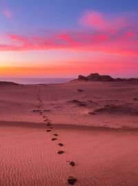 Scenic view of desert against sky during sunset