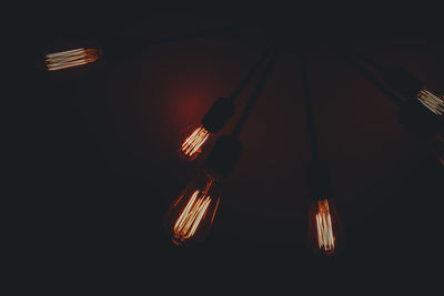 Low angle view of illuminated light bulbs