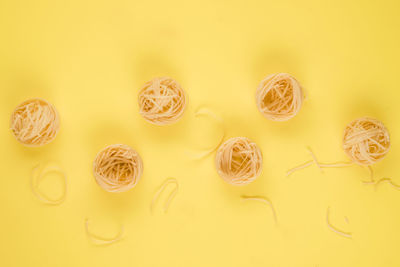 High angle view of candies against yellow background