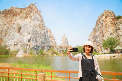 Portrait of woman standing on rock