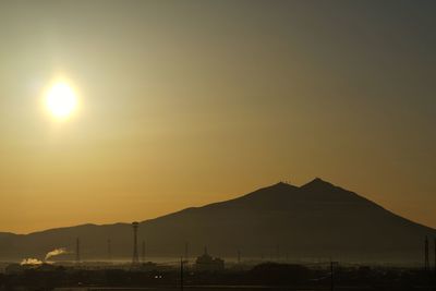 Scenic view of silhouette mountains against sky during sunset