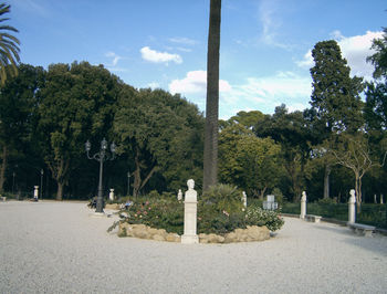 Trees in cemetery against sky