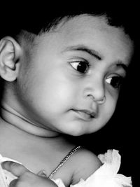 Portrait of cute baby girl looking away