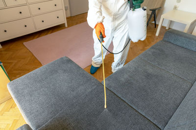 Low section of man standing on floor at home