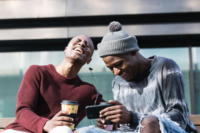 Man holding smart phone outdoors