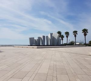 View of buildings by sea against sky