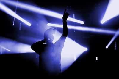 Close-up of man singing on illuminated stage