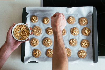 Overhead view of a young man making cookies at the kitchen