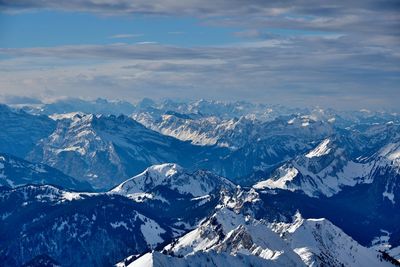 Aerial view of snowcapped mountains against sky