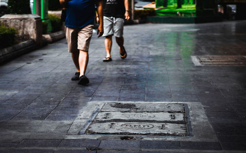 Low section of people walking on footpath