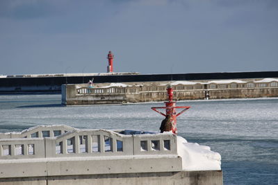 View of lighthouse by sea against sky