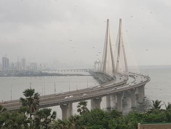 Panoramic view of bridge and cityscape against sky