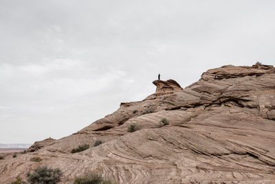 Low angle view of a man staying on a rock